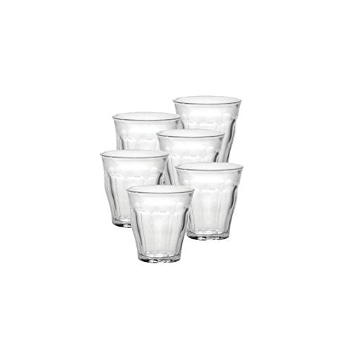 Set of six clear glass tumblers on a white background