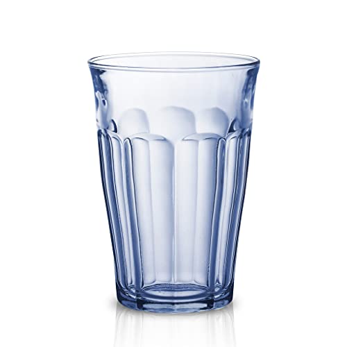 Blue glass tumbler with textured design on a white background
